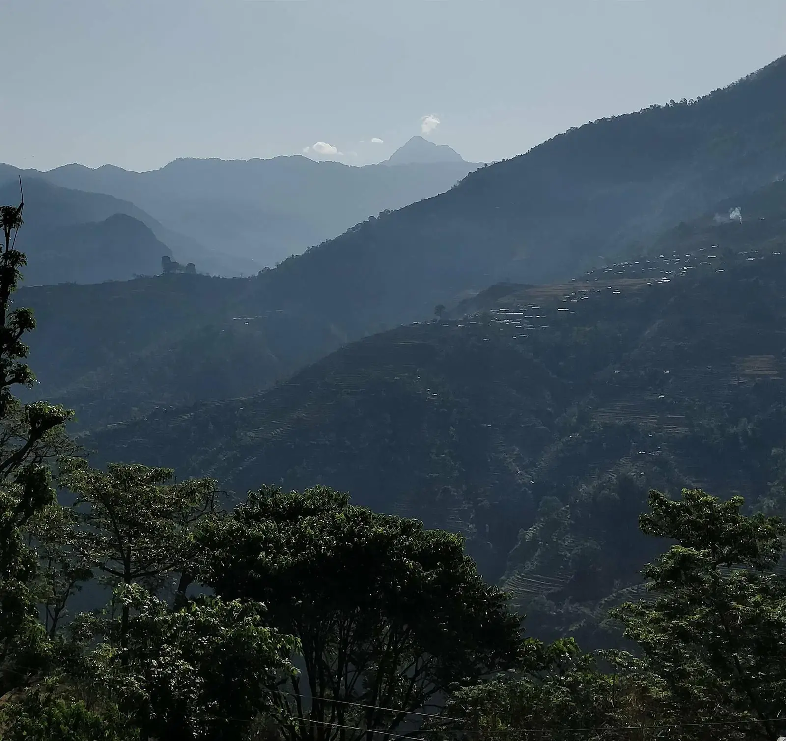 Layered blue ridgelines of Far-West Nepal with a distant peak